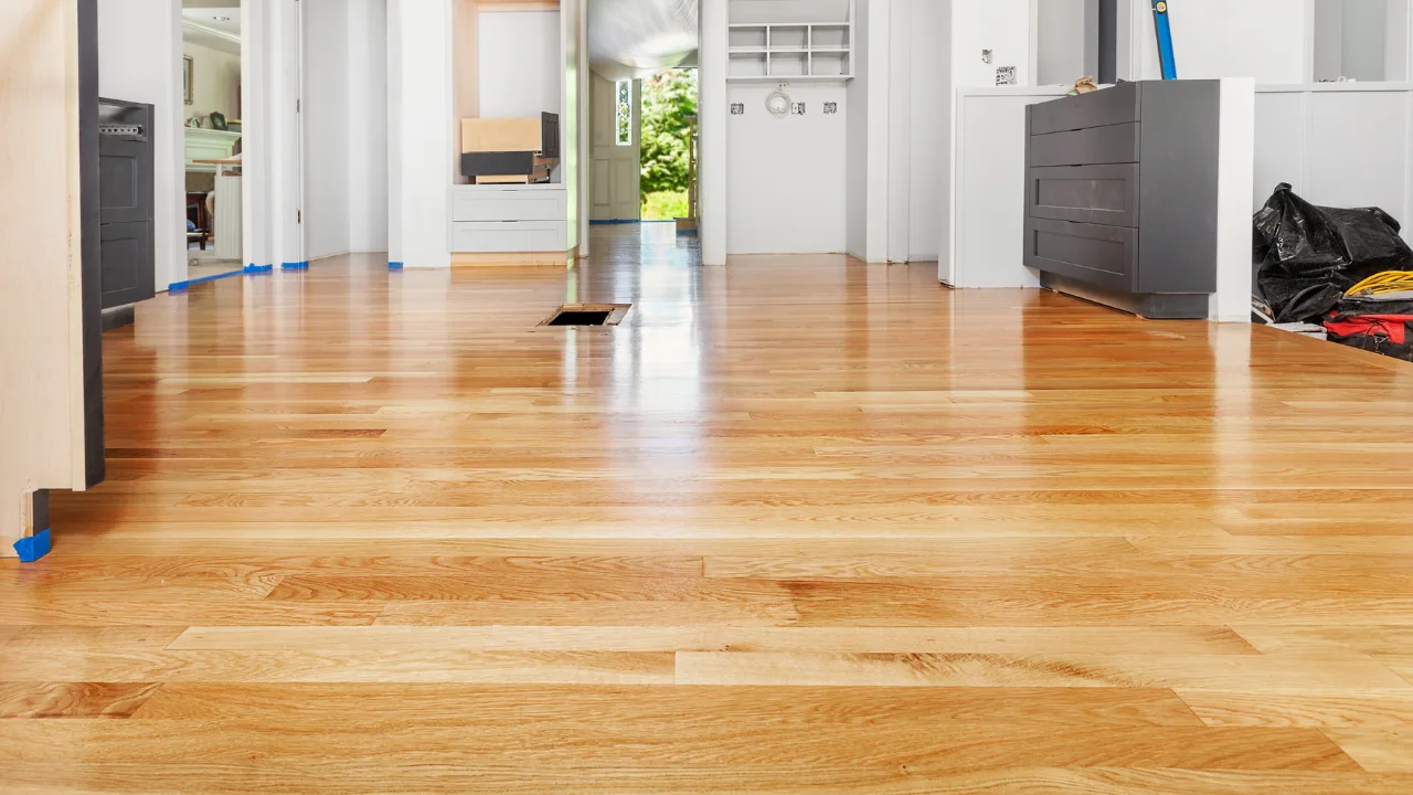 Floors To You OKC installer fitting a wide-plank engineered wood board