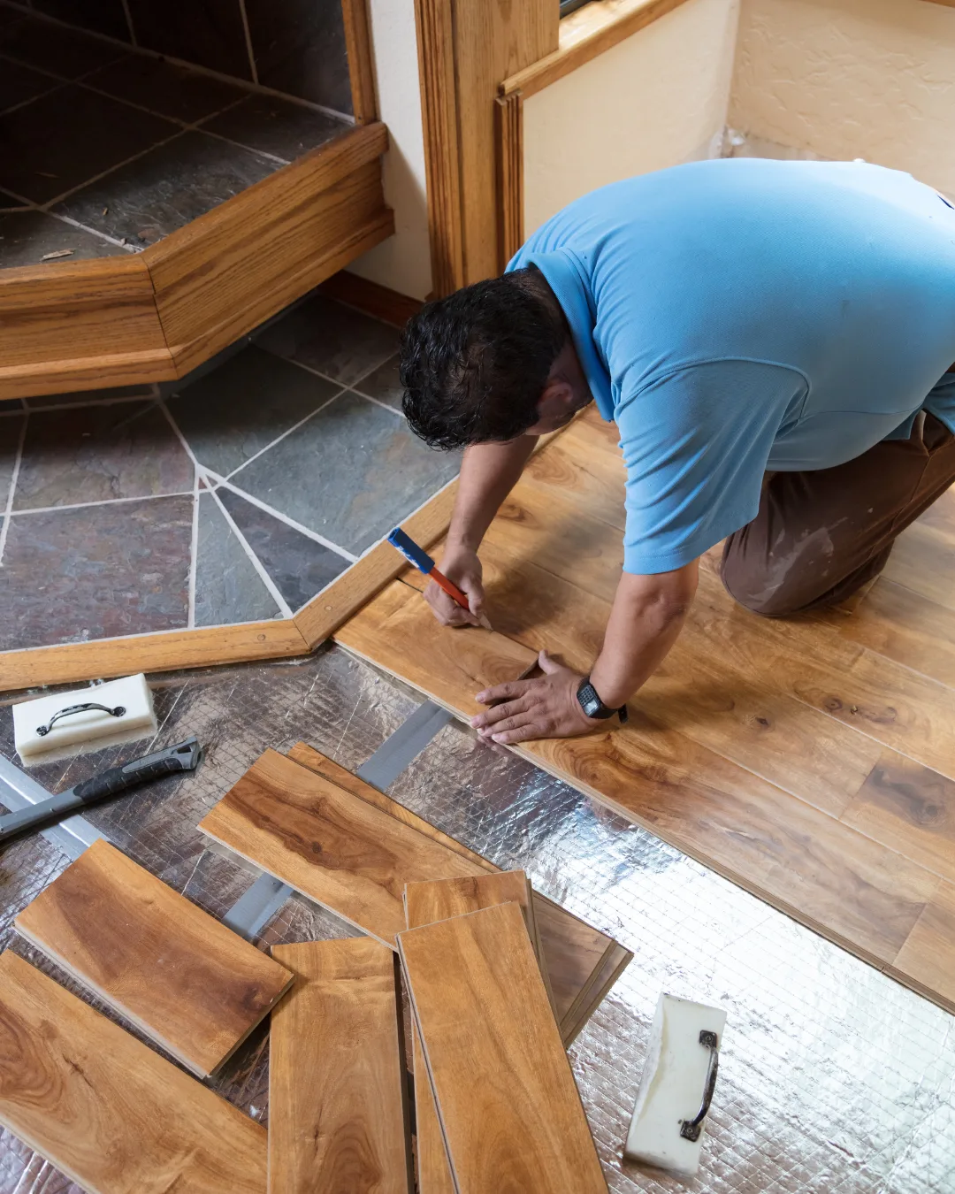 Floors To You OKC consultant measuring a room for a new floor estimate